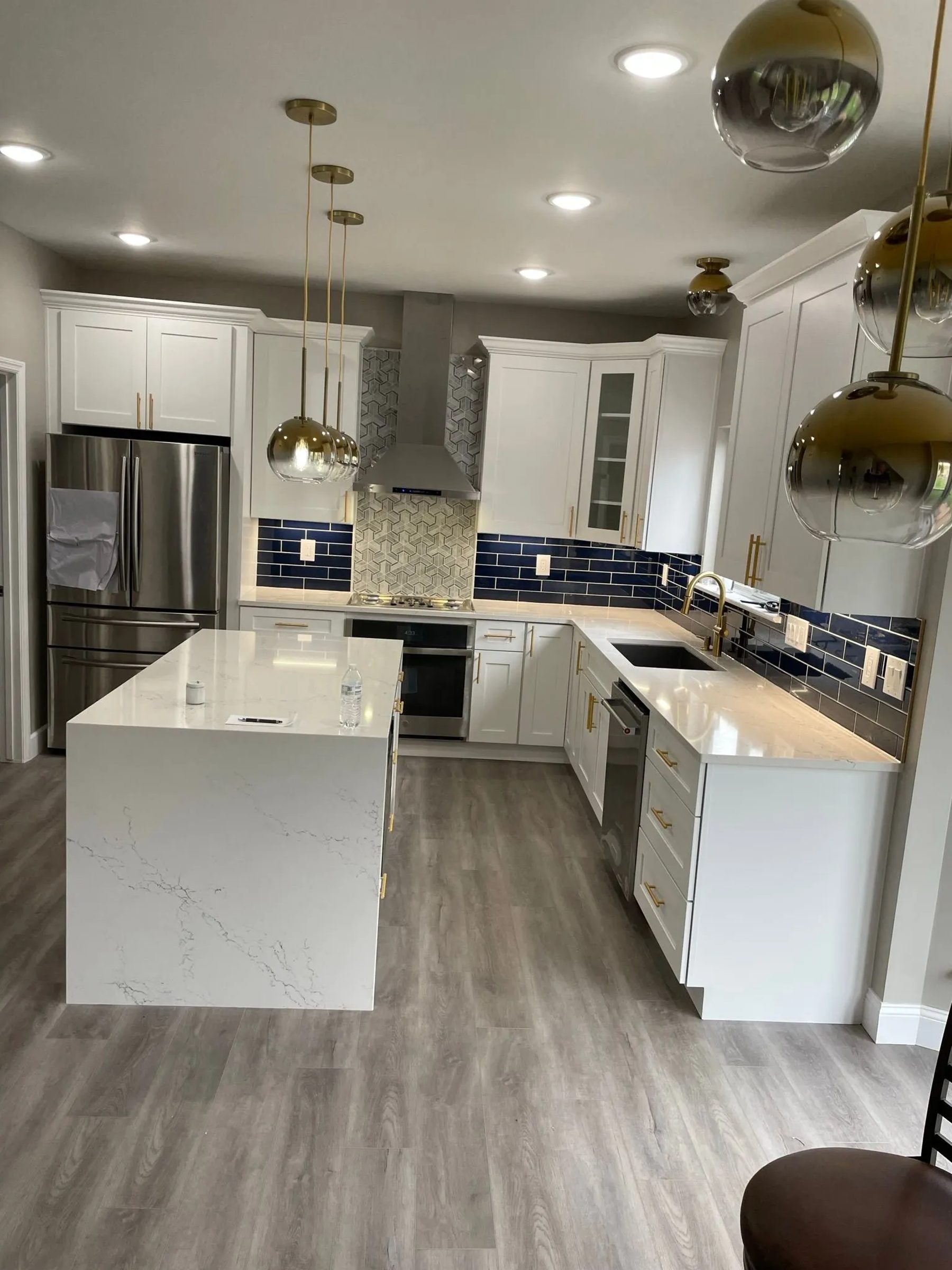 Custom white kitchen remodel with waterfall island by Premier 1 Properties